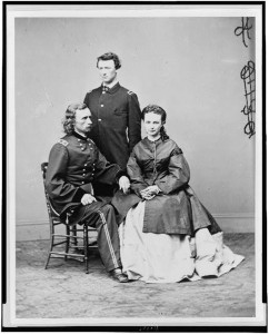 George Armstrong Custer, in uniform, seated with his wife, Elizabeth "Libbie" Bacon Custer, and his brother, Thomas W. Custer, standing, circa 1865. 